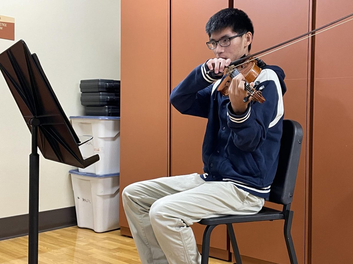 Ian Li warming up before his string quartet rehearsal.  